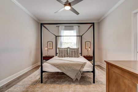 Master bedroom w/ a canopy bed & en suite bathroom for a private retreat feel.