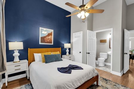 Bright white bedroom w/ a plush bed & clean, airy feel — rest easy here.