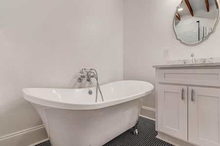 Elegant freestanding soaking tub — the kind of bath you actually look forward to.