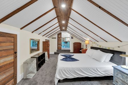 Bright loft bedroom w/ vaulted ceilings & a relaxed, airy feel.