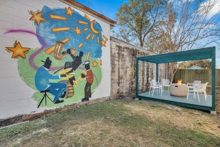 Lively courtyard mural bursting w/ color & true NOLA spirit — an outdoor space with character.