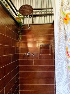 Warm-toned tiled shower — the perfect place to wash off the day.
