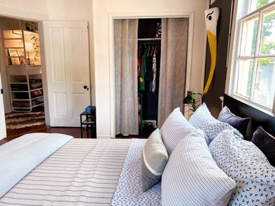 Well-lit exterior entrance w/ a bold yellow door, perfect for evening arrivals.