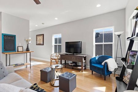 Open living space w/ a TV, blue accent chair & plenty of room to spread out.