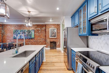 Functional kitchen space w/ ample storage & striking blue cabinets.