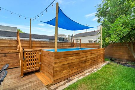 Private outdoor pool shaded by a blue sail — a refreshing midday retreat.