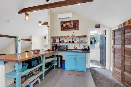 Upstairs kitchen w/ breakfast bar & vintage-inspired touches.