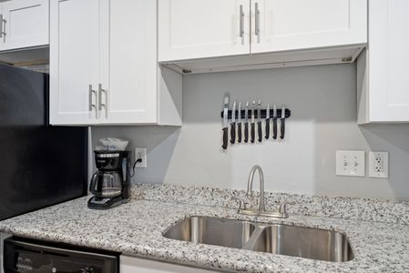 Compact & clean kitchen nook stocked w/ everyday essentials to keep you fueled.