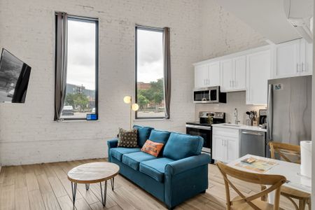 Kick back in a soulful living room with high ceilings, classic architectural touches, and the spirit of New Orleans just outside your window