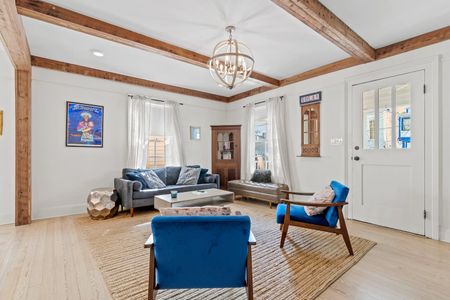 Bright living room w/ New Orleans-inspired decor & cozy blue seating.