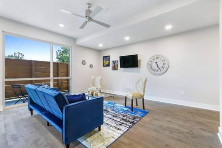Spacious living room w/ smart TV & blue accent seating for movie nights in.