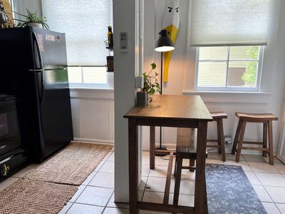 Dining area w/ a wooden table & pendant lighting for shared meals.