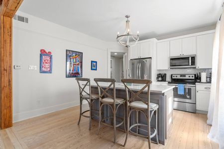 Stylish kitchen w/ large counter island — great for gathering & extra dining space.