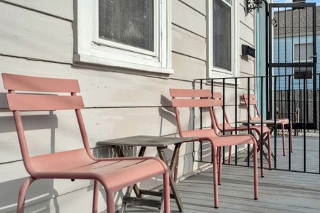 Charming dining space w/ pink chairs & an airy feel, great for a casual meal together.