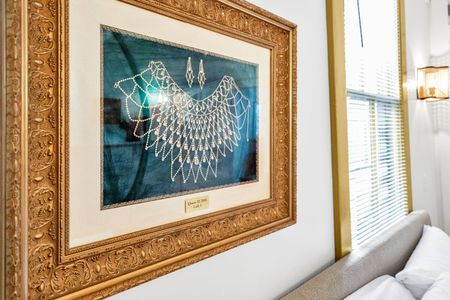 Gold-framed coastal artwork that brings local character to the walls.