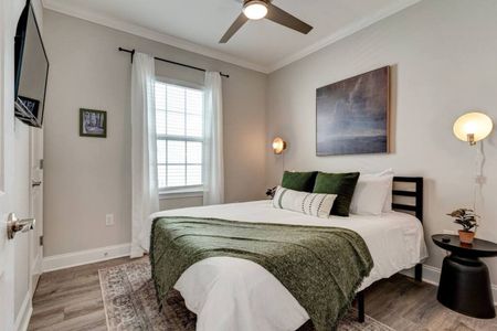 Calm bedroom w/ soft green accents & warm, inviting lighting.