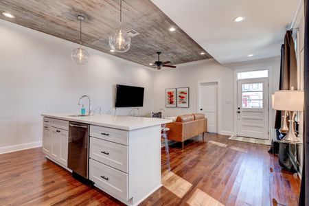 Open-concept kitchen & living area filled w/ natural light & modern finishes.