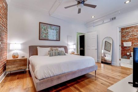 Spacious master bedroom w/ a king bed & warm, inviting decor.