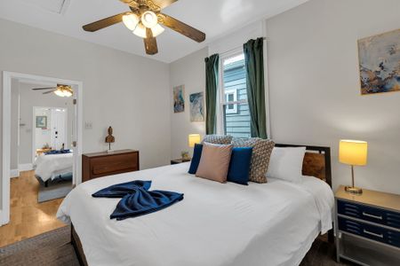Warm bedroom w/ layered bedding & soft natural light for an easy, restful night.