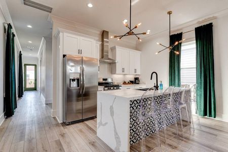 Chef's kitchen w/ sleek counters, stainless appliances & plenty of prep space.