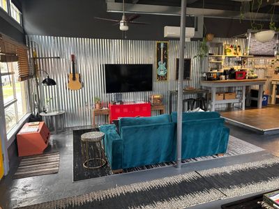 Cozy living area w/ a bold teal sofa — settle in & make yourself at home.