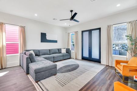 Kick back in the airy living room w/ a plush sectional and cool-toned decor.