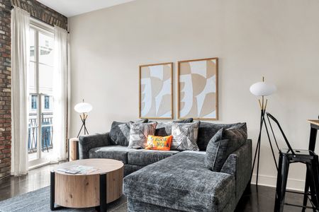 Sink into the plush sofa w/ warm natural light filling the living room.