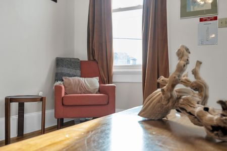 Snug armchair tucked in a warm corner — the perfect spot to curl up & get lost in a book.