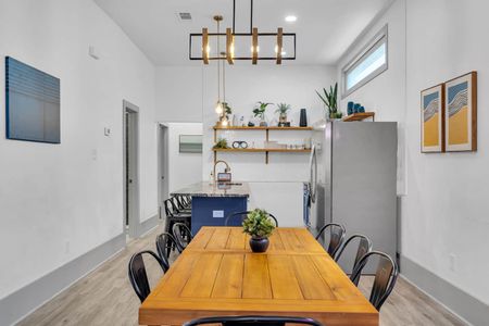 Bright dining nook w/ a wood table & natural light — a great spot for morning coffee.