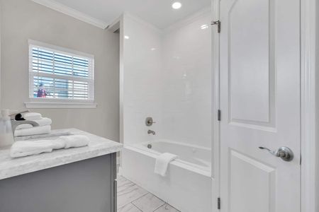 Primary bathroom featuring a tub & shower combo for a relaxing soak or rinse.