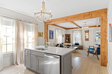 Warm living space w/ chandelier, comfortable seating & a welcoming layout.