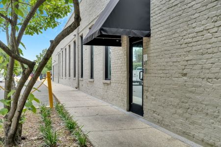 Inviting stone exterior w/ lush greenery framing the entrance.