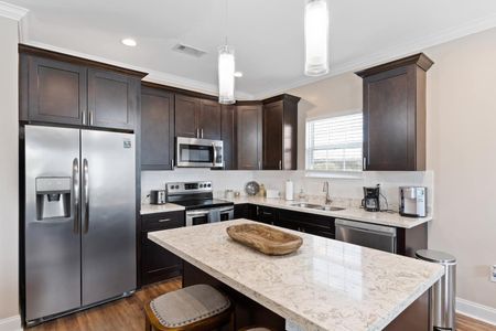 Kitchen island w/ bar stools — a casual spot to enjoy meals or morning coffee.