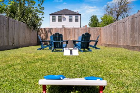Blue Adirondack chairs, cornhole & open sky — your backyard hangout awaits.