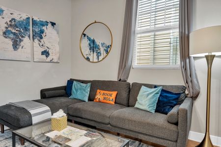 Relaxed living room sofa w/ colorful pillows & a laid-back local vibe.