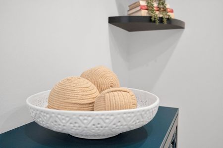 Decorative woven bowl adds warmth & texture to the space.
