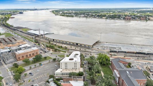 Aerial view of the riverfront with the wide, winding river in full view.