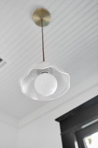 Clean, sculptural ceiling light adding a subtle design touch overhead.