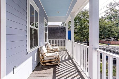 Covered balcony w/ seating — the perfect perch for a quiet morning coffee.