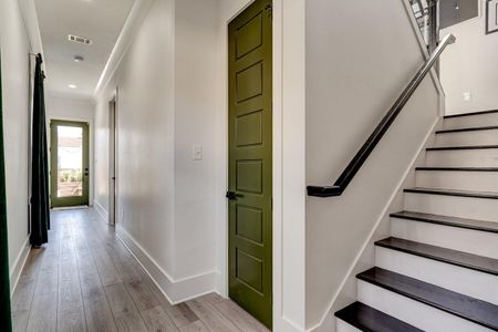 Hallway behind the kitchen leading to the stairs & additional spaces.