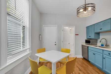 Airy dining nook w/ a clean white table, perfect for morning coffee or a home-cooked meal.