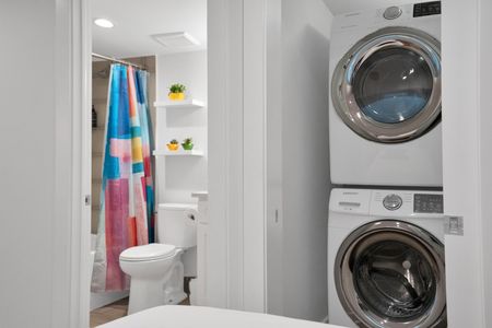 Convenient in-unit laundry w/ washer & dryer tucked neatly behind a stylish door.