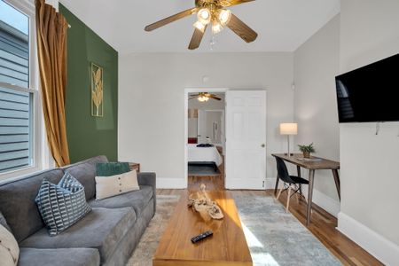 Light-filled living space w/ stylish green accents & modern finishes throughout.