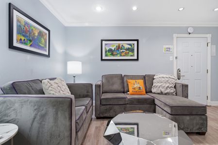 Gather around in this warm living room w/ plush sofas & welcoming energy.