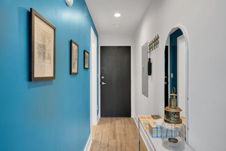 Clean, welcoming entryway w/ a charcoal door & teal walls to set the tone.