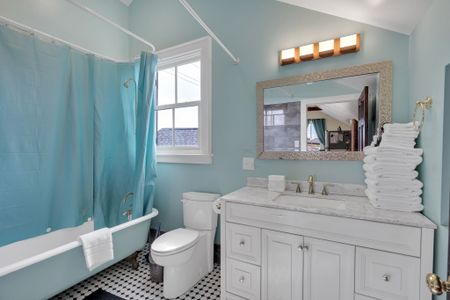 Full bathroom w/ double vanity & soothing blue tones.
