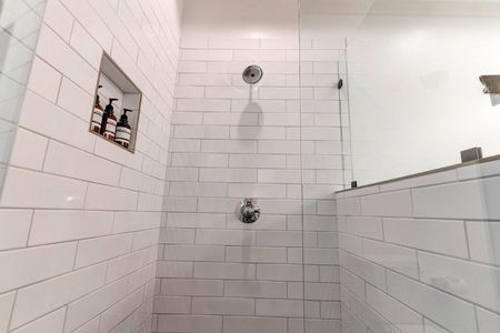 Bright bathroom w/ subway tile walls & a soaking tub for unwinding in style.
