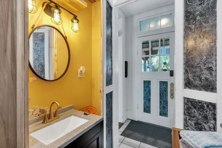 Bold, sunny bathroom w/ vibrant NOLA color & character.