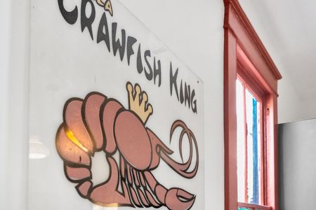 Playful nod to local culture w/ vibrant crawfish-themed wall art.