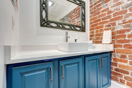 Bathroom vanity w/ sink & plenty of counter space.